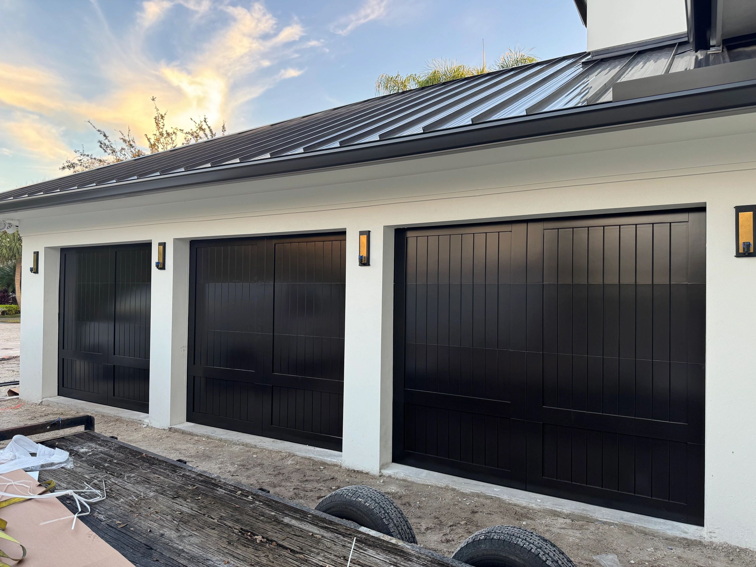 Three black garage doors residential